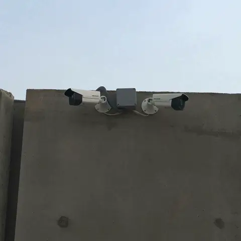 Perimeter cameras on a compound wall